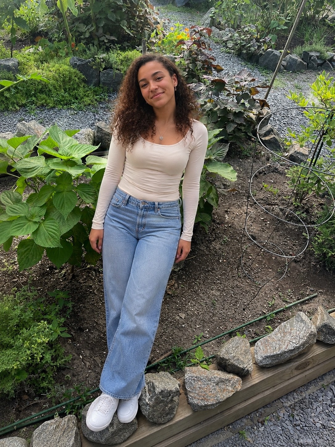 Research participant standing within a densely planted urban garden habitat